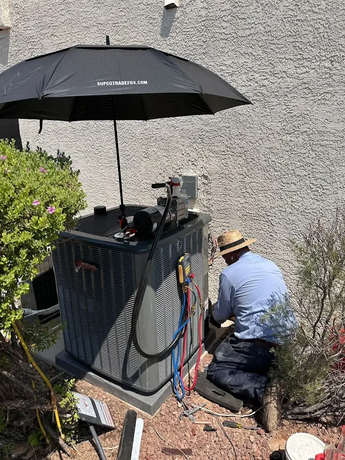 HVAC technician performing outdoor AC maintenance in Sandpoint